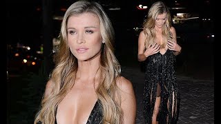 Joanna Krupa, 39, grapples with her cleavage-baring dress in Poland