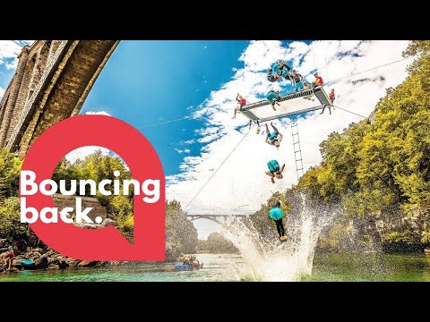Acrobats perform mind-blowing jumps from a trampoline suspended from a bridge | SWNS