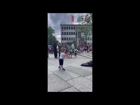 Amazing kid  dances to busker with harmonica in front of Cologne Cathedral (Kölner Dom)