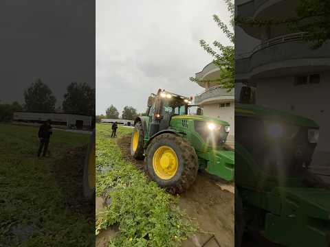 JOHN DEERE IS USING A TRACTOR TO DIG A WATER CANAL