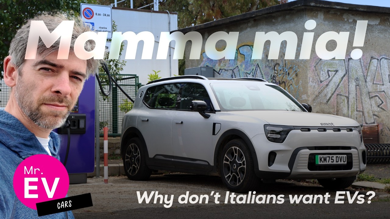 Andrew Till from Mr. EV standing next to a rapid charger in a small Italian town while explaining Italy's EV adoption challenges
