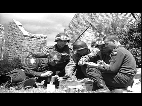 US troops eat rations in a bivouac area following D-Day invasion of Normandy (D-D...HD Stock Footage