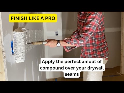Using a paint roller to apply compound over drywall seams
