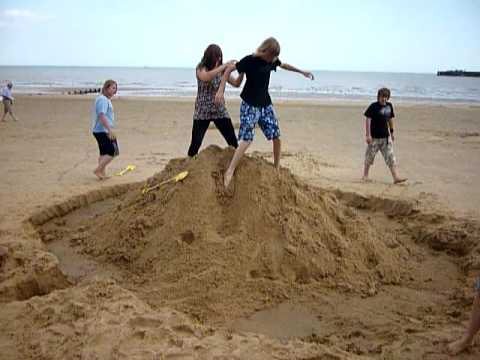 Group Take Down Big Smiley Sandcastle