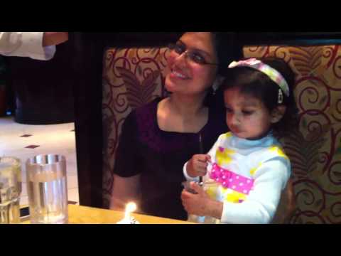 Saisha blowing candle on mommy's cake