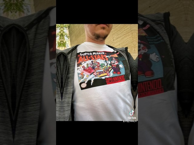 Vídeo relacionado con Nintendo Camiseta So Mario para Hombre, Azul Marino Jaspeado, X-Large