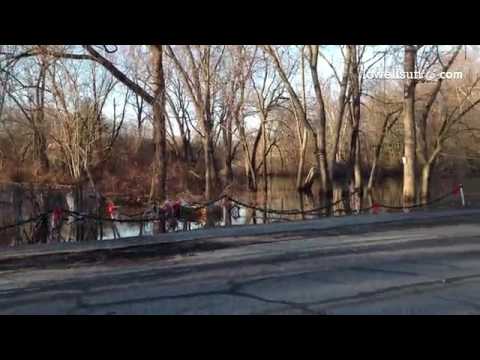 Flooding of a yard and Christmas decorations underwater on Princeton Blvd in Lowell Tuesday.@lowells
