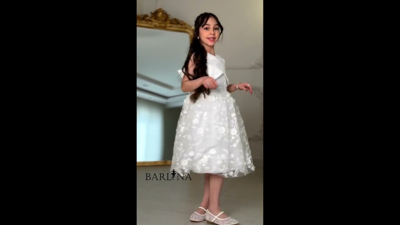 Soft white girls' dress with a cross-neck - year 1