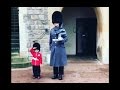 Boy Dressed as British Guard Salutes Windsor Castle Soldiers