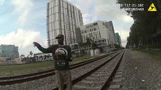 Man With Loaded Gun Standing On Train Tracks