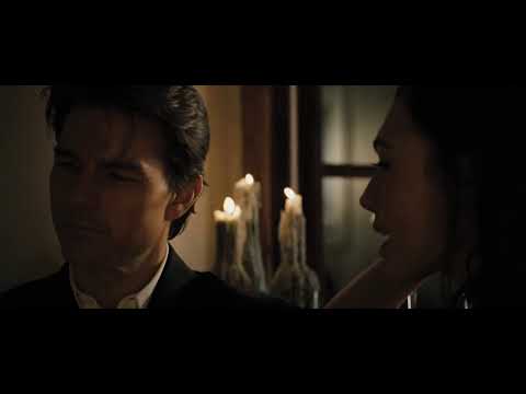 Official trailer frame: June and Roy buckled into a turbulent passenger jet as chaos erupts