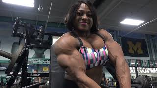 FBB Andrea Shaw flexing shredded biceps