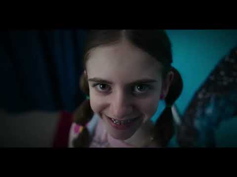 Smile 2 trailer frame: fans at meet-and-greet, smile motif creeping across faces as pop track thumps