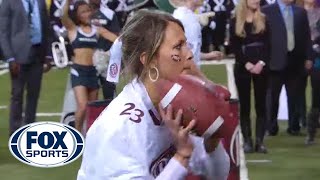 Girl wins $100,000 throwing football with two hands