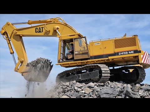 Cat 245B Working with Broken Rock.