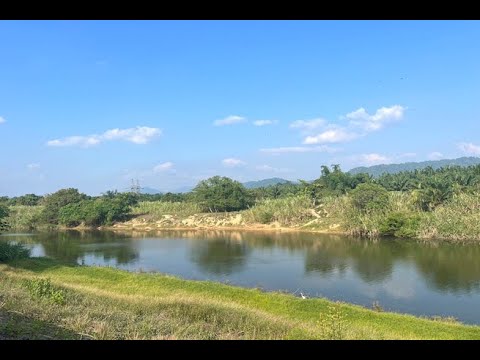 Almost 10 Rai Land Plot with Canal and Mountain Views for Sale in Takua Pa, Phang Nga