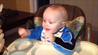 Baby laughing hysterically at ice chewing
