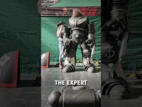 Putting on a gigantic space marine cosplay! 🤩😮  -  🎥 coraxion_cosplay