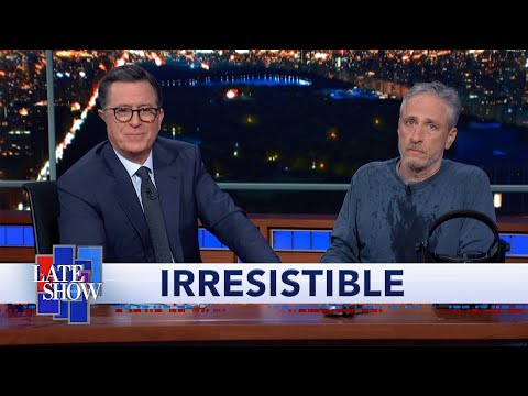 ジョン・スチュワートがコルバートのデスクの下から出てきて、「Irresistible」の映画予告編を公開しました。 (Jon Stewart Climbs Out From Under Colbert's Desk To Debut "Irresistible" Movie Trailer)