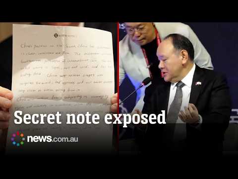 Awkward moment Chinese diplomat’s secret note is read out loud in front of live audience