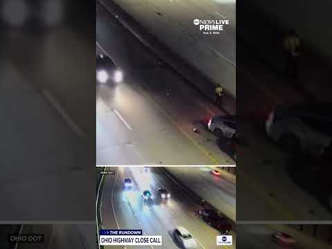 Person narrowly escapes car on freeway shoulder