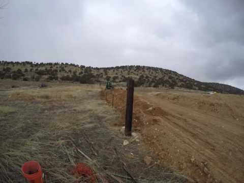 Timelapse of building rock retaining wall  with Bobcat 334 part1