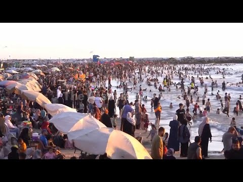 Palestinians in Gaza City flock to beach to escape scorching heat of summer as lengthy war continues