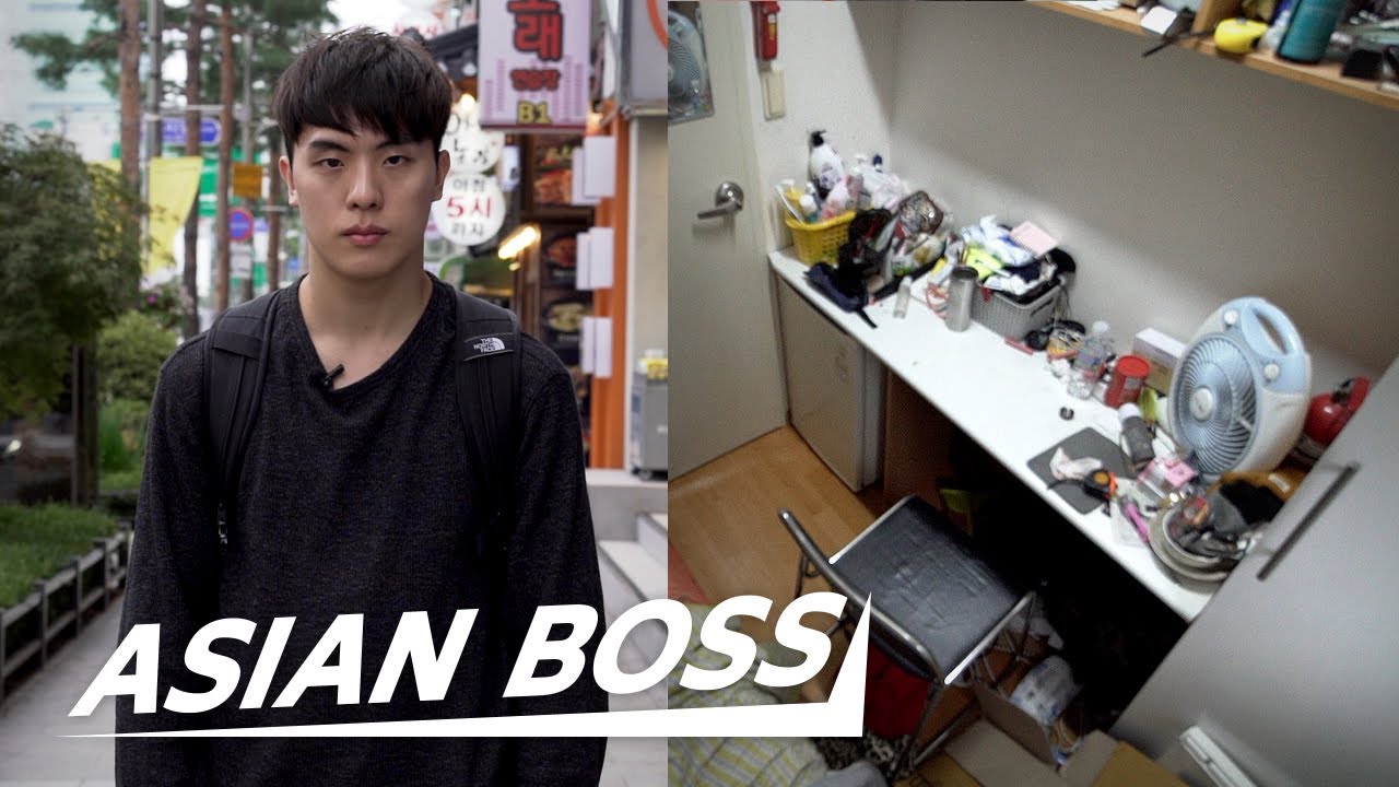 An interview-style documentary still showing a Korean gosiwon resident sitting in their small room sharing their experience living in this affordable housing