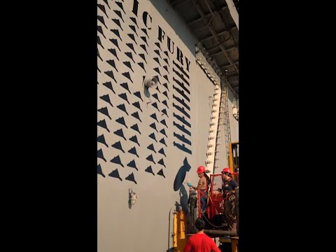 USS Lincoln sailors show off symbolic mural on ship