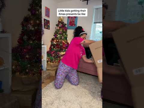 Little kids opening Christmas Presents