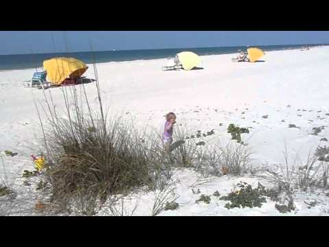 Kenna walking in sand