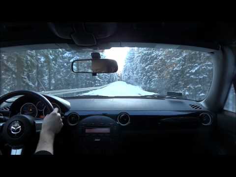 Early morning drive on a snowy mountain road