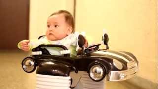 baby in a car style walker cruising down the hallway