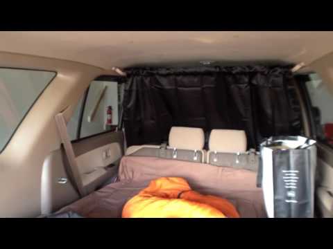 Part of a video titled How to Hang Clothes or a Curtain in Your Car - YouTube