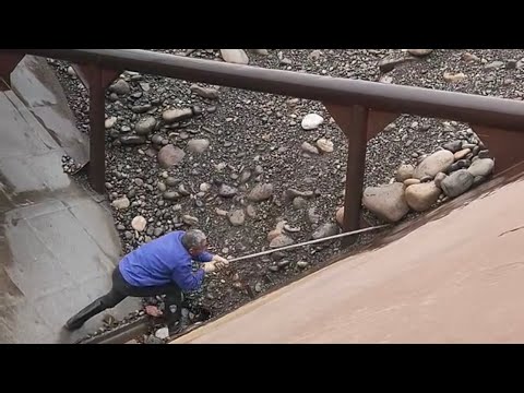 Barge unloading large size cobblestone - hard worker
