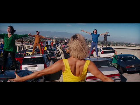 Trailer frame: dusk skyline and street lamps before the hilltop tap duet, hinting at jazz harmonies and romantic tension