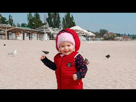 baby improves walking skills by walking on sand on the beach (10 month old)