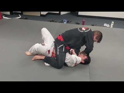 Jean Jacques Machado Rolling with White Belt Student