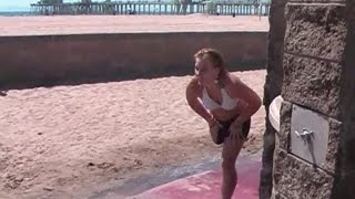 Young amputee single crutch on beach