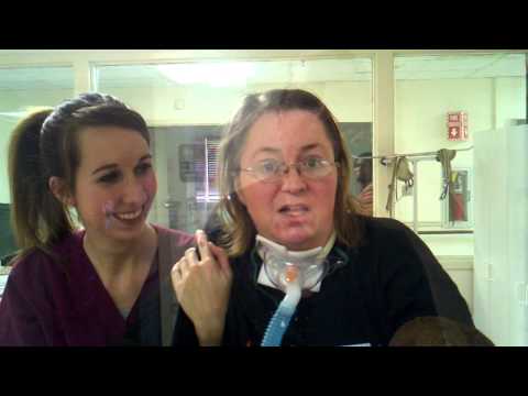 Lori standing 8 months after stroke.