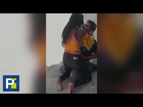 A woman stabs her partner and seconds later begs for forgiveness amidst kisses and hugs.