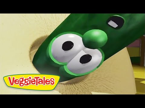 Animated green cucumber character with big eyes from VeggieTales, on a beige background with the VeggieTales logo in the corner.