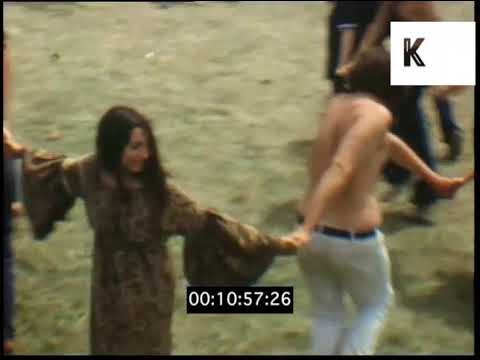 1960s, 1970s USA, Hippies Dancing Together in Field