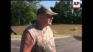 In Mt. Carmel, Illinois a man takes his wife and sister to safety by boat, but heads back to his hom