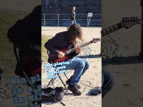 guitar man in park. Milan, Italy. Sforza Castle