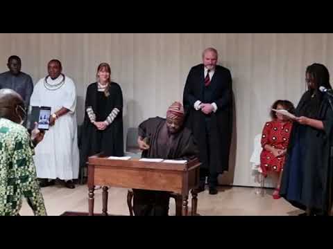Amb. Sarafa Isola signs the legal handover documents of Benin Bronze from Jesus College Cambridge