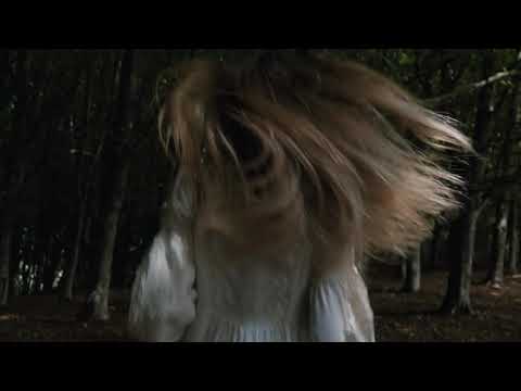 Woman running in a dark forest