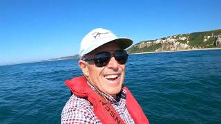 Man Fishing Alone in a boat on Jurassic Coast: Rough Sea Surf n’ Turf Cookup
