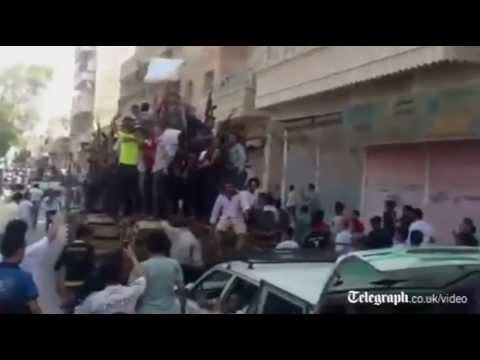 Syrian rebels parade captured tank though Aleppo