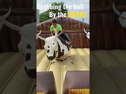 First try on a mechanical bull!  Noah’s turn!  #cowboys #fair #mechanicalbull #event